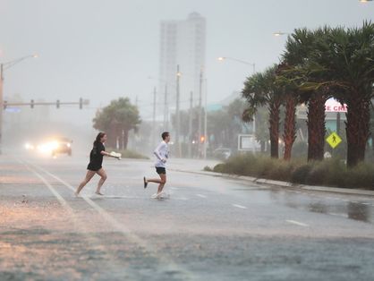 fotografia de pessoas correndo na chuva