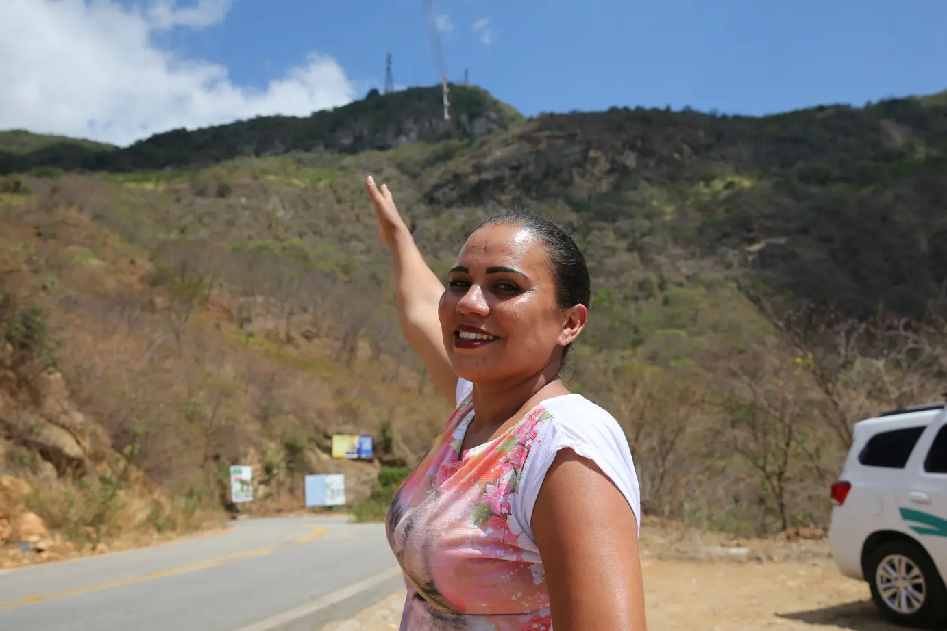 Mulher aponta pra o Maciço de Baturité
