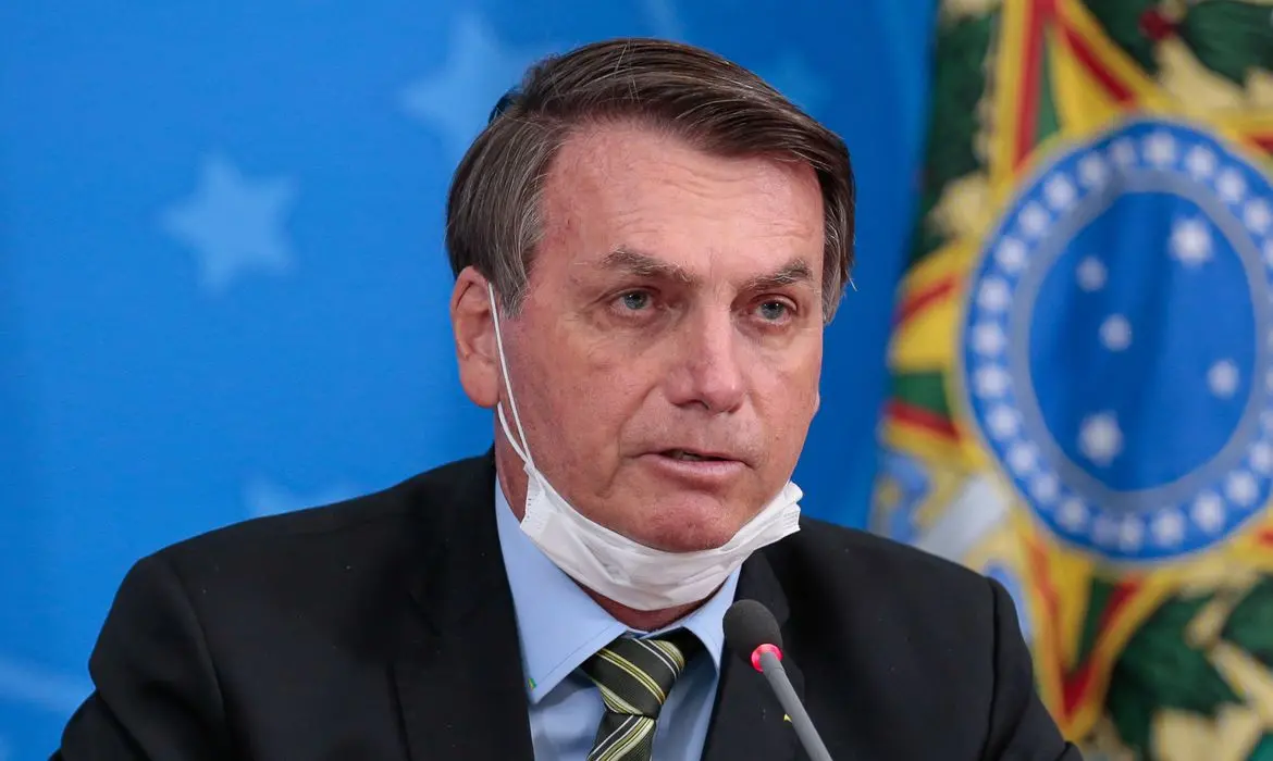 Bolsonaro com a máscara no queixo durante coletiva de imprensa
