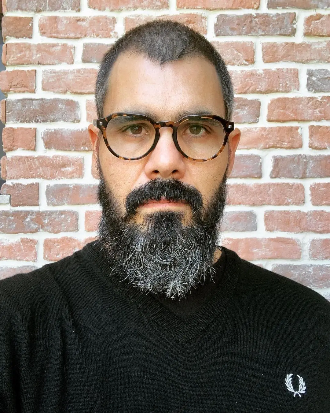 Ator Juliano Cazarré de blusa preta e óculos