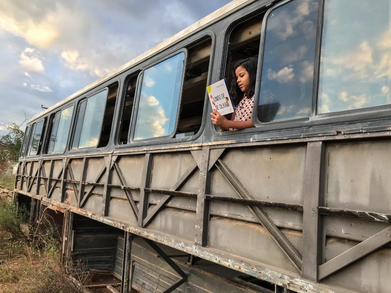 Ana Lívia, 7 anos, lê dentro do onibus-sucata na comunidade de Espinho - Limoeiro do Norte