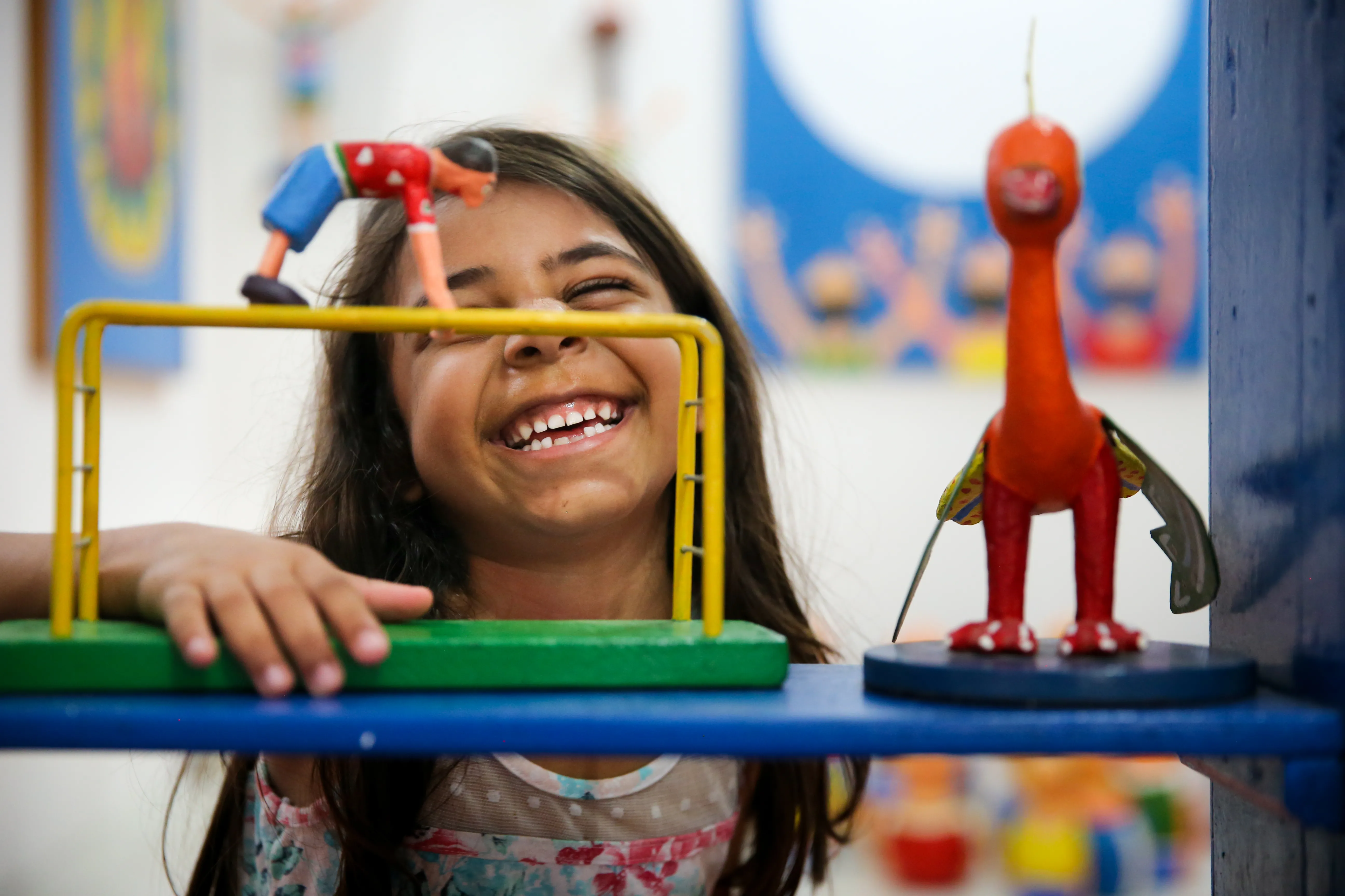Pequena descobre peças de artista plástico em exposição do Dim Brinquedim