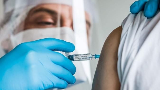 Profissional de saúde aplicando vacina contra a Covid-19