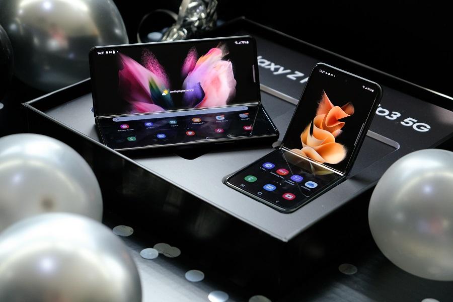 Dois aparelhos Galaxy Z Fold 3 5G na cor preta, abertos em cima de uma caixa