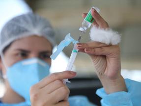 Enfermeira manipula seringa com vacina contra a Covid-19