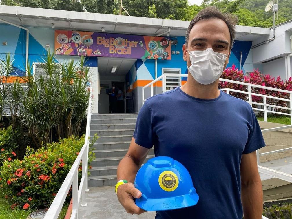 Tadeu Schmidt na fachada da entrada da casa do BBB 21