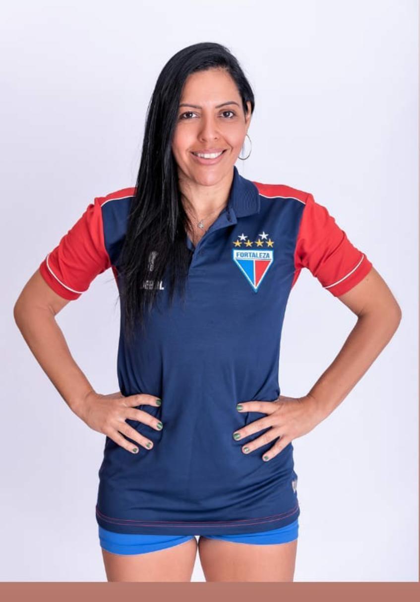 Imagem mostra mulher em pé, usando camisa do Fortaleza.