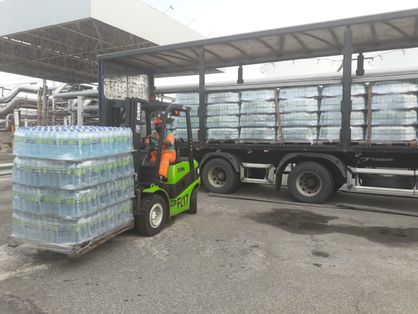 caminhão transporta fardos de água para doação