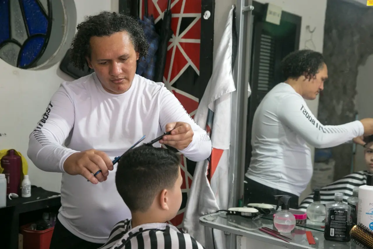 Profissional corta o cabelo de uma criança