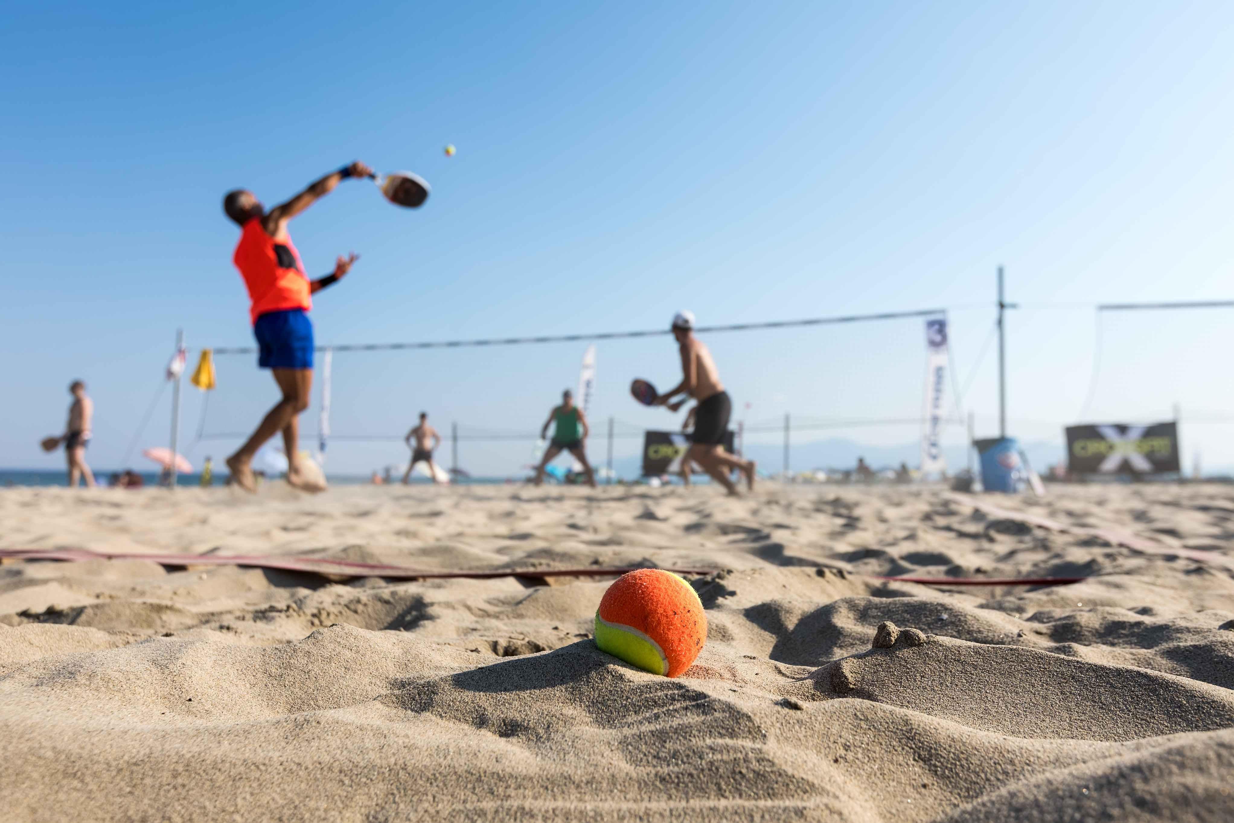 Homens jogando Beach Tennis na areia de uma praia