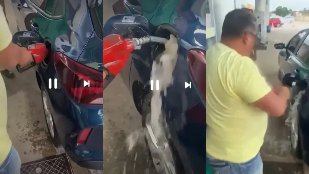 Homem tira a bomba de gasolina da mão do frentista para deixar que combustível derrame.