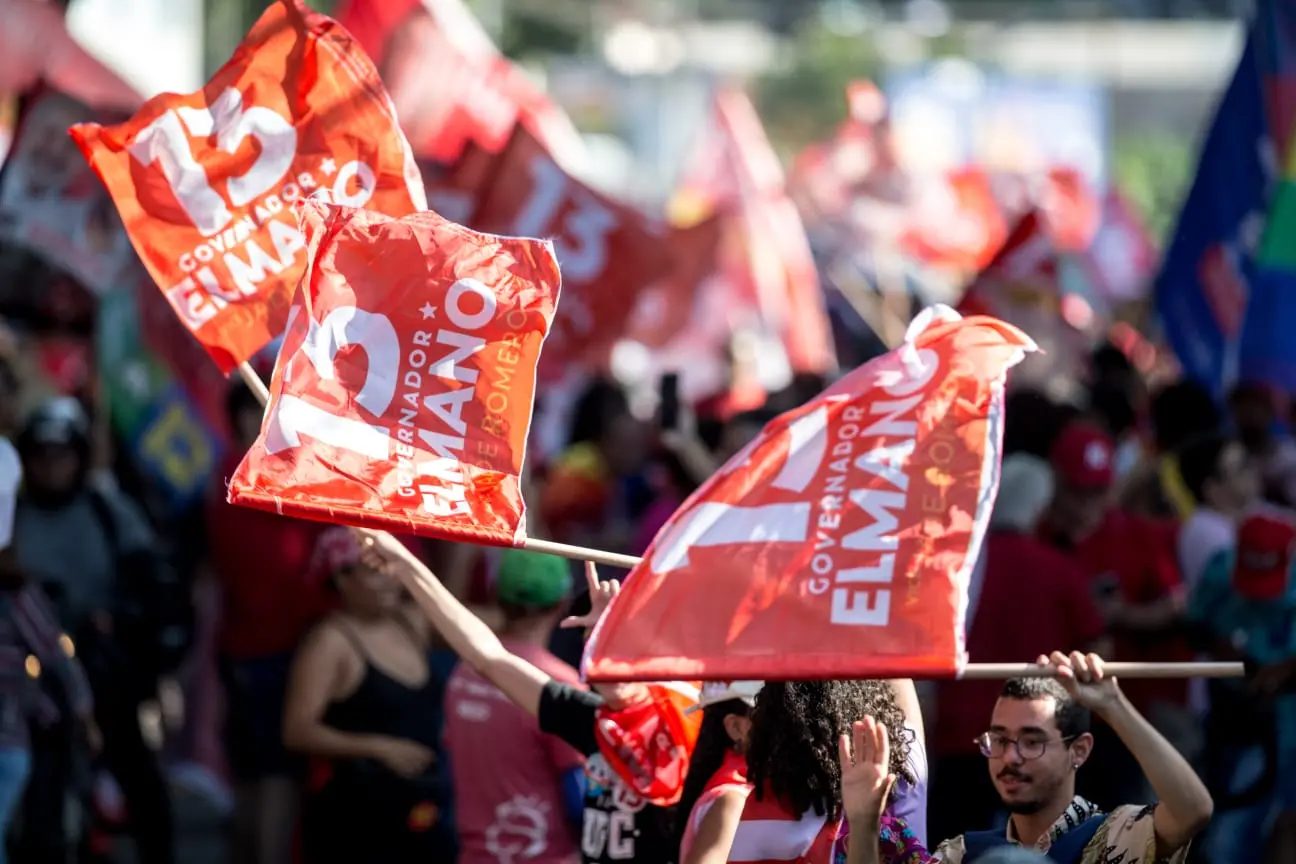Militantes do PT seguram bandeiras de apoio a Elmano, Camilo e Lula no Centro de Fortaleza