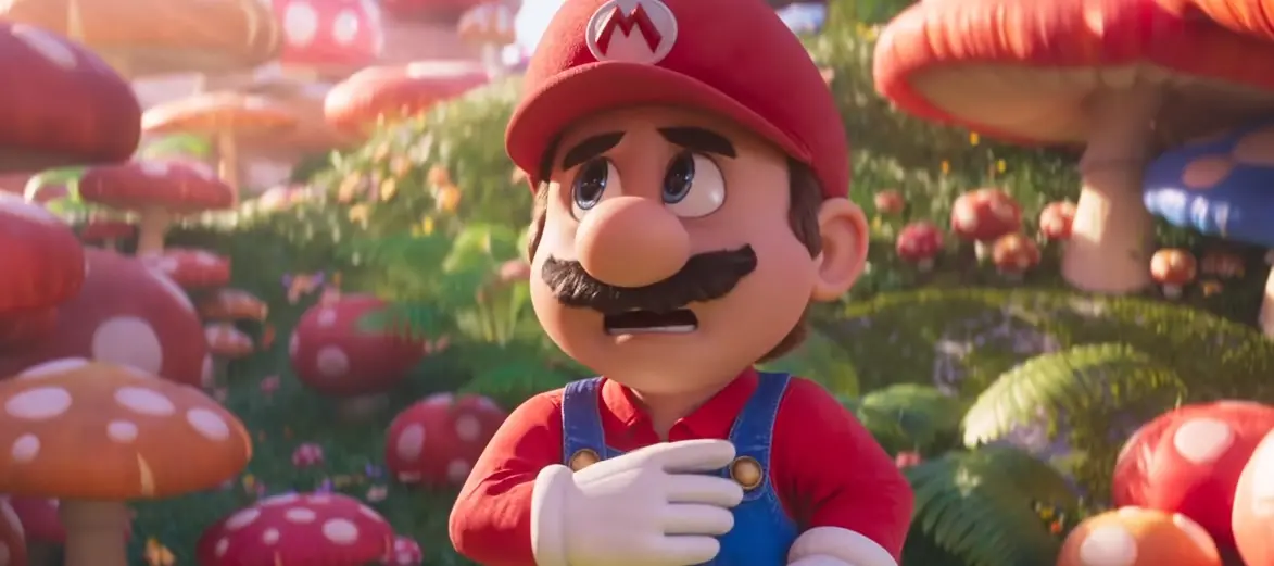 O personagem Super Mario é um homem baixinho e bigodudo que veste um macacão azul por cima de uma blusa vermelha.
