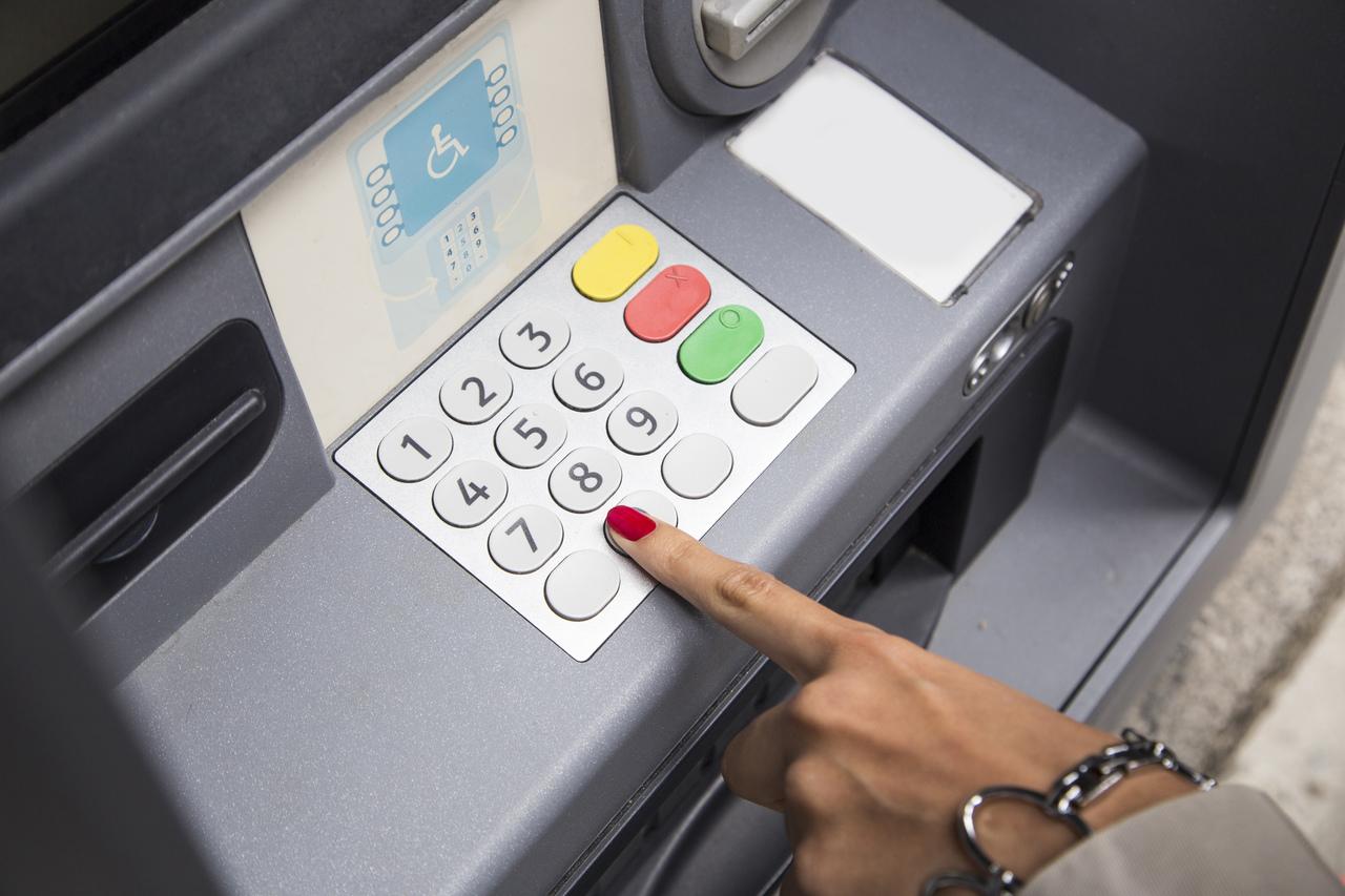 pessoa mexendo no caixa eletrônico