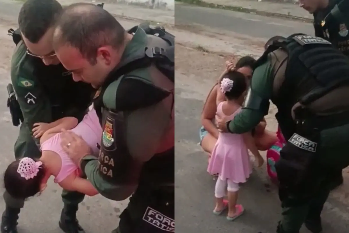 policiais fazendo manobra de heimlich para salvar menina engasgada com bombom