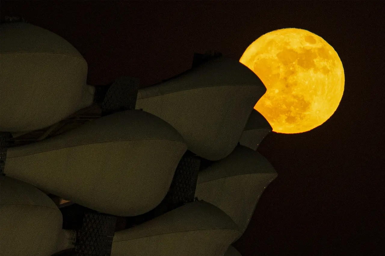 'Superlua dos Cervos' surge atrás do Estádio Internacional de Basra, na cidade de Basra, no sul do Iraque, em 3 de julho de 2023.