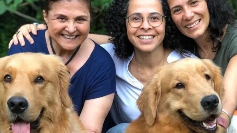Elizângela, sua nora, Micheline Torres, e sua filha, Marcelle Sampaio, posam para foto com dois cachorros da raça golden retriever