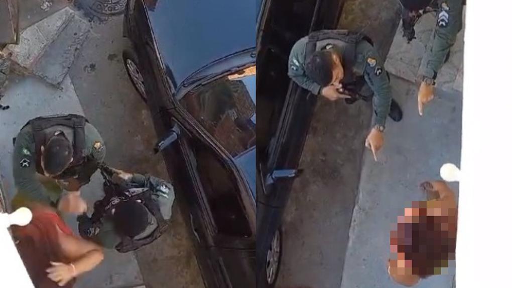 print de vídeo onde policiais abordam mulher e um deles empurra ela