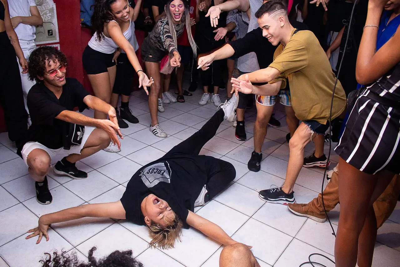 Performer realiza um dip, movimento icônico do vogue; torcida do público é parte essencial das balls