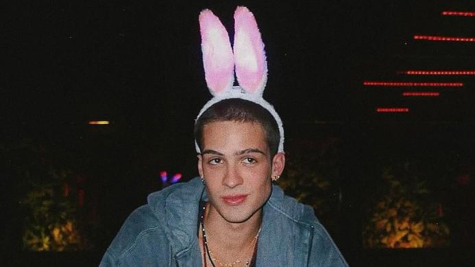 Foto do ator João Guilherme com um artigo que imita orelhas de coelho