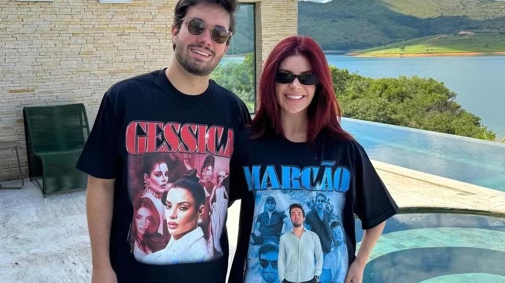 Marco Túlio e Gkay posam para fotos com camisetas estampadas com o rosto de cada um