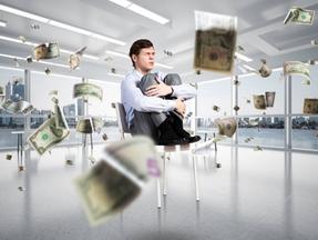 Arte mostra homem sentado em cadeira e abraçando as pernas com notas de dólares voando