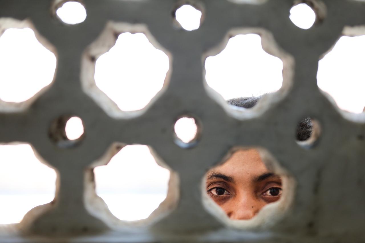 Olhos de mulher olhando por cobogós 