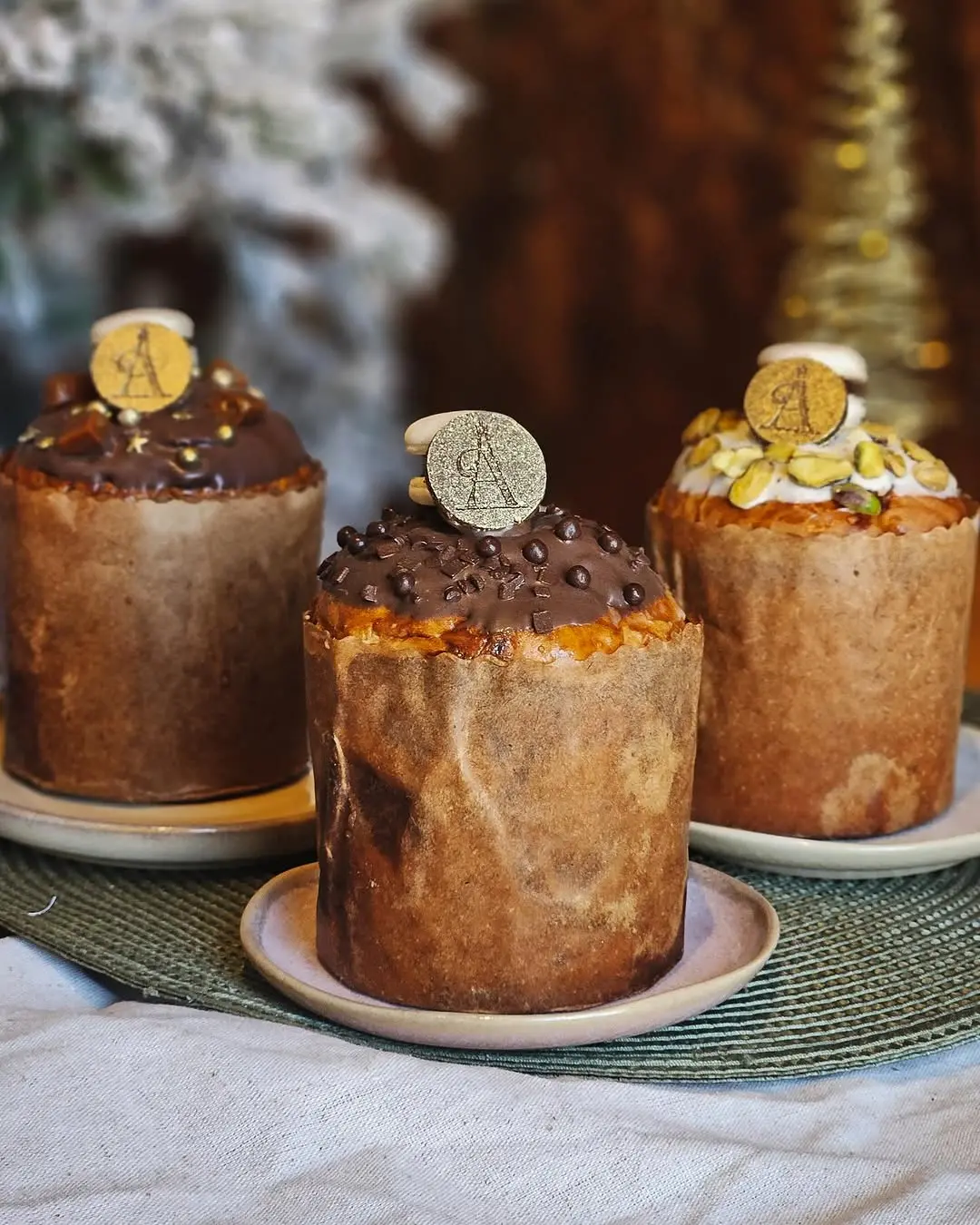 a imagem mostra três opções de panetones da Ale Felix sobre a mesa com itens decorativos para o Natal de Fortaleza