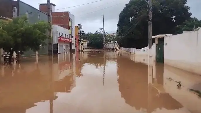 Rua tomada por água da chuva misturada com lama