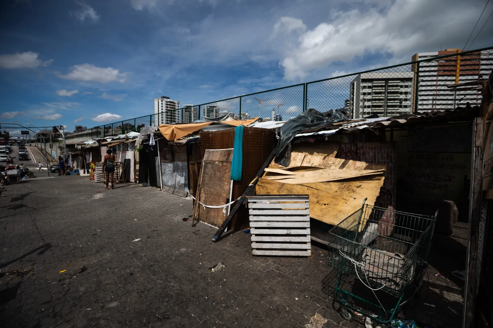Barracos de madeira, papelão e móveis reciclados se erguem ao longo da Via Expressa, no Papicu