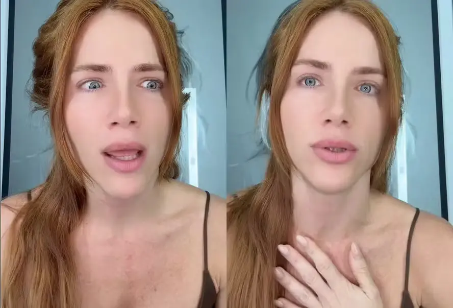 Giovanna Ewbank com cabelos longos e castanhos claros e expressão facial intrigada, em fundo neutro, retratando uma reação emocional.