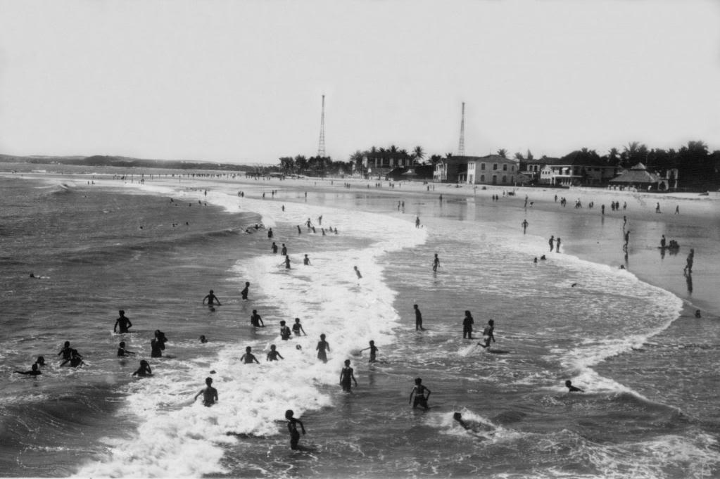Foto antiga em preto e branco Praia de Iracema na década de 1930, com várias pessoas tomando banho de mar
