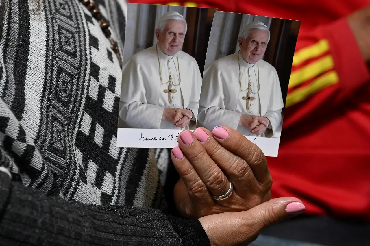 foto de pessoa segurando imagens do papa bento xvi