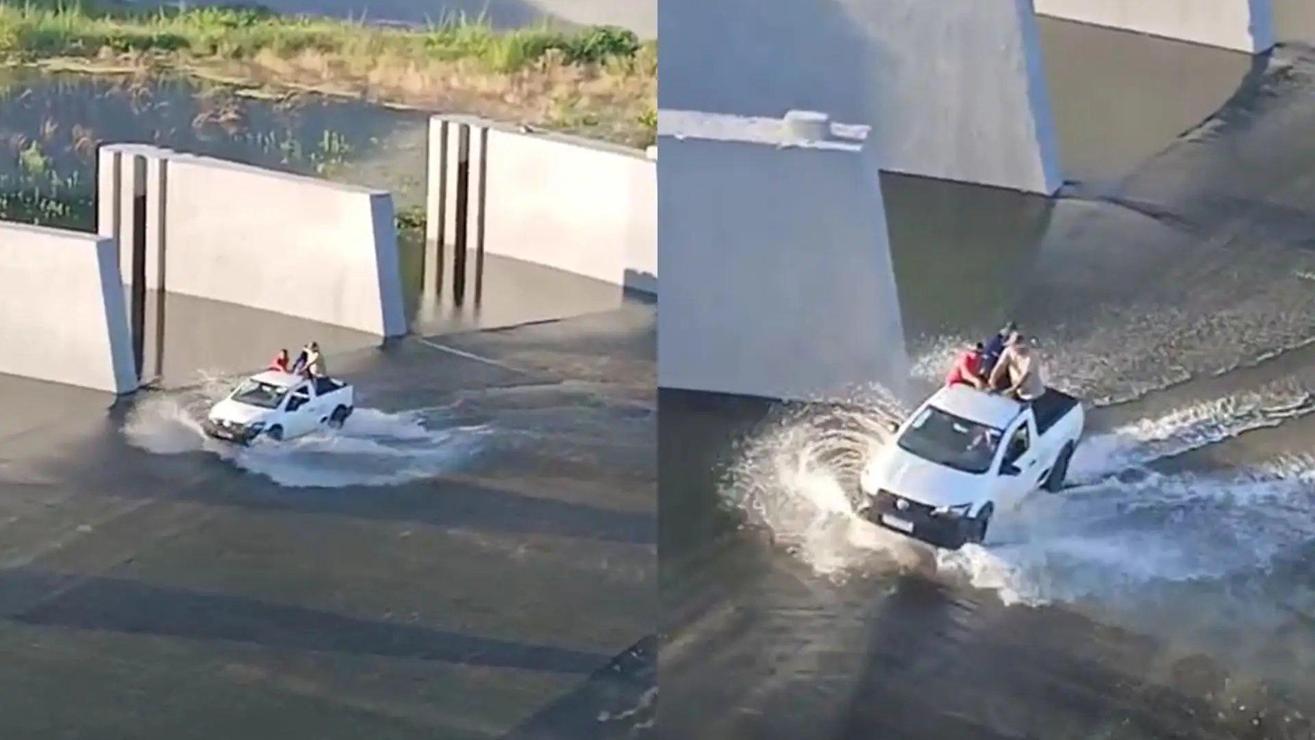 Homens de carro sobre barragem do a&ccedil;ude Or&oacute;s