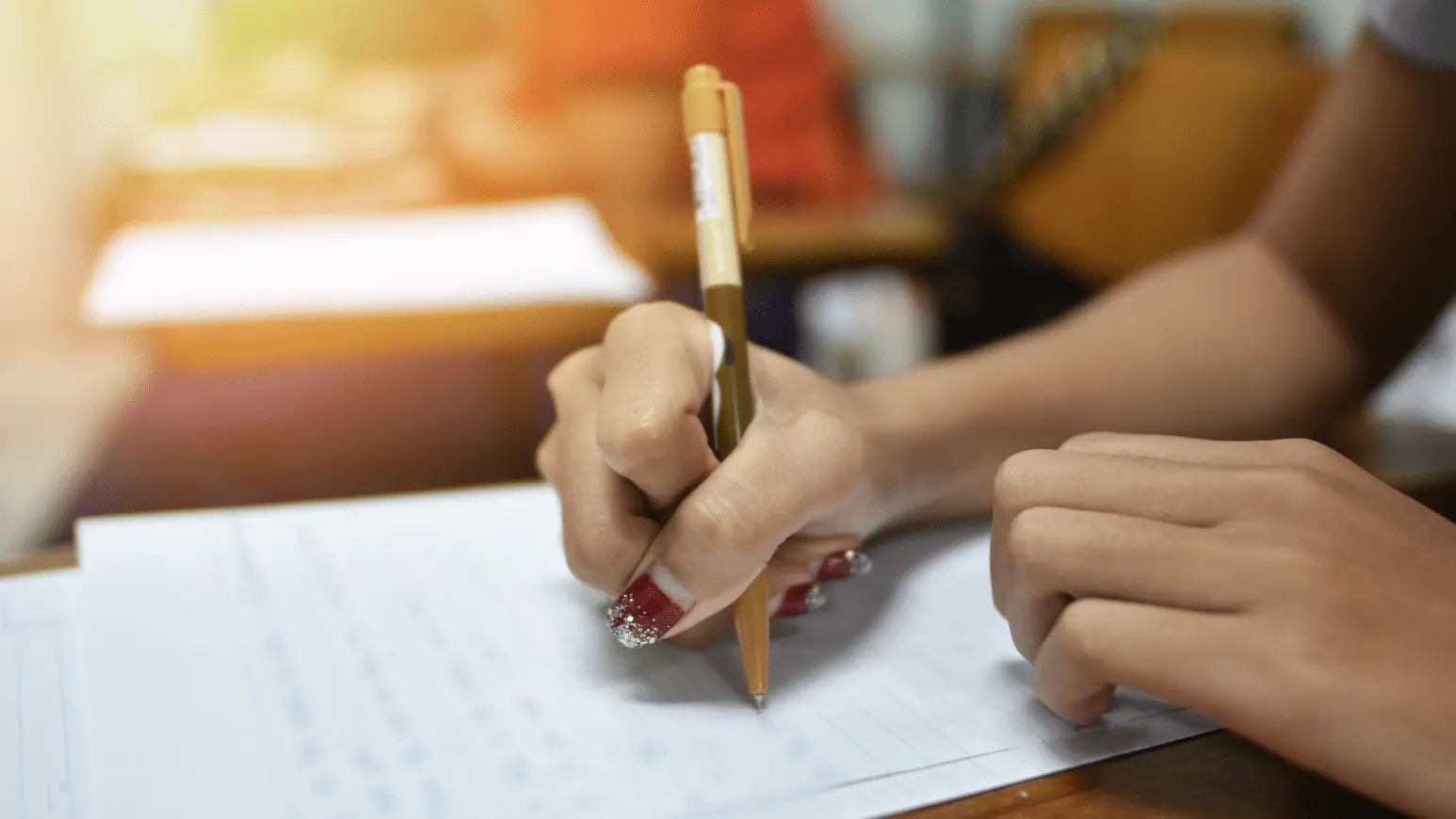 Pessoa realizando uma prova de questões de múltipla escolha, preenchendo respostas com uma caneta em uma folha de teste. Concurso Conab: locais de prova do certame serão divulgados nesta quarta (9), após às 19h.