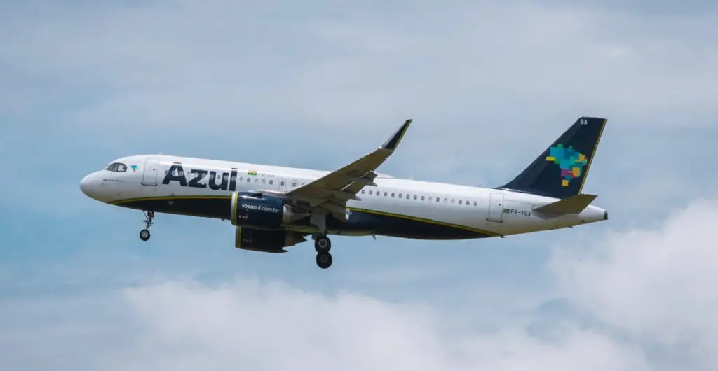 Aeroporto com várias aeronaves da TAM Linhas Aéreas estacionadas em frente ao terminal, visto de cima em uma manhã ensolarada.