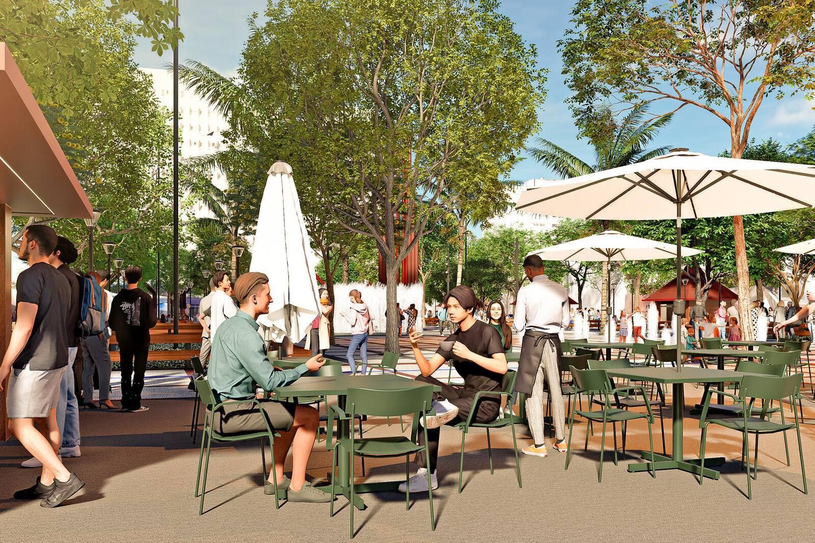 Imagem de computação gráfica detalha uma área com mesas e cadeiras verdes de futuro quiosque na Praça do Ferreira, com grandes guarda-sóis brancos. Pessoas sentam, conversam, e outras transitam ao redor.