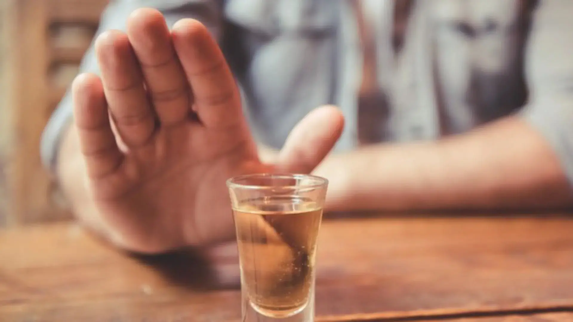 Copo de bebida e uma mão. Imagem usada em matéria sobre aumento de 113 casos de intoxicação por metanol.