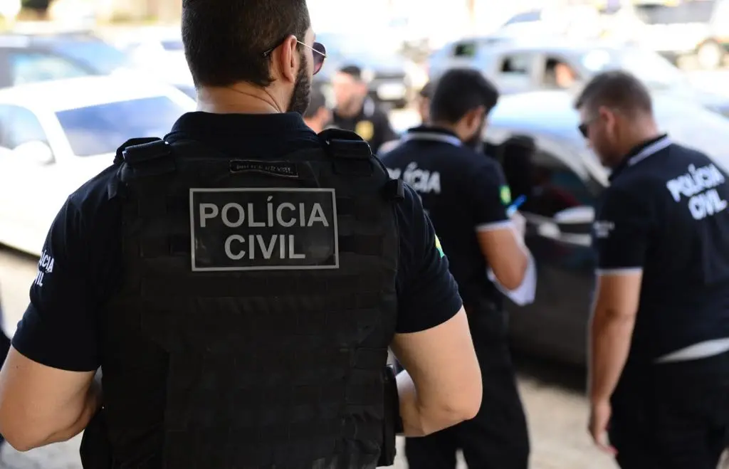 Foto mostra policiais civis de costas, fardados, em ação no Ceará.