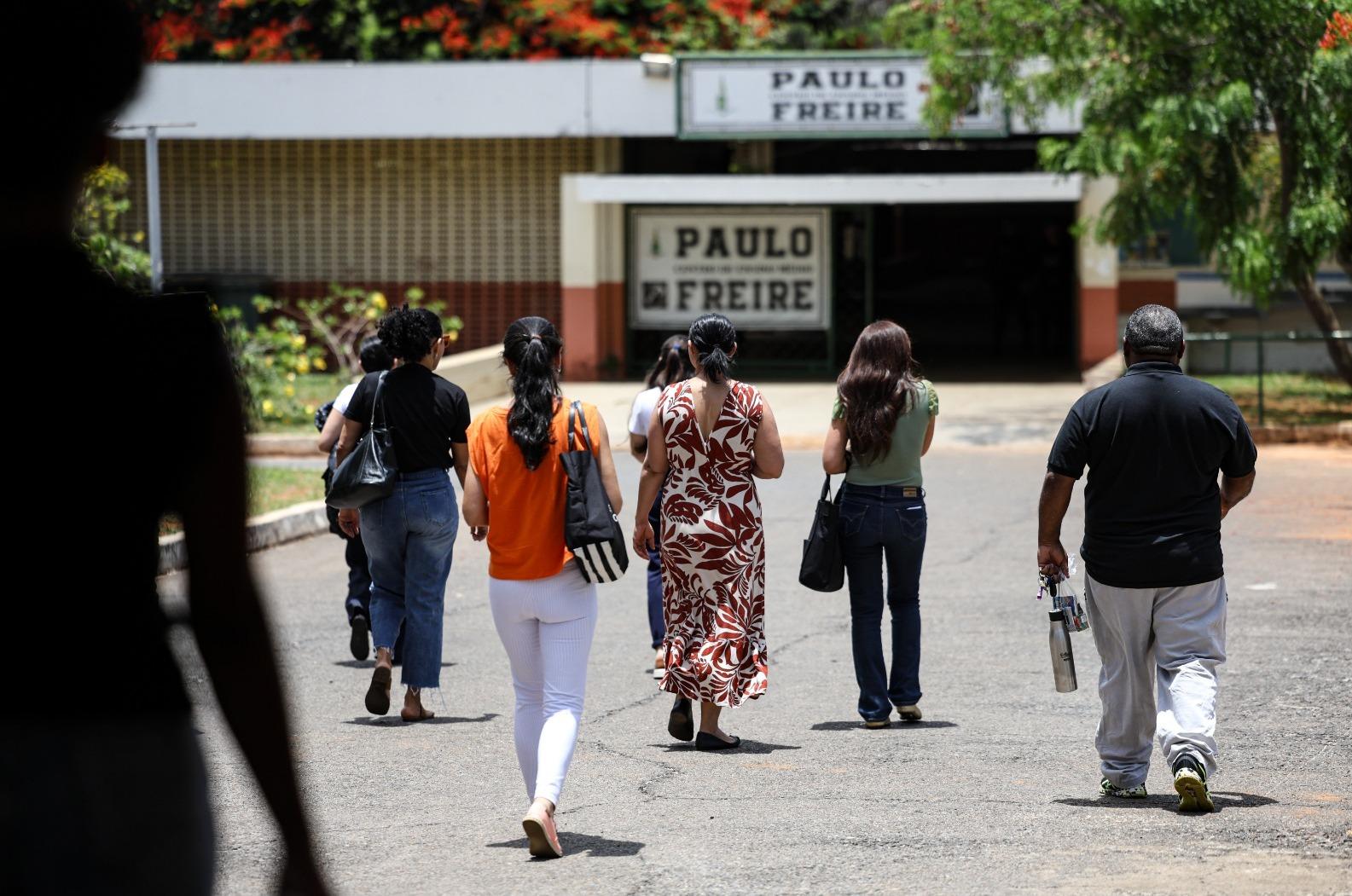 Professores caminham em direção a local de prova do PND.