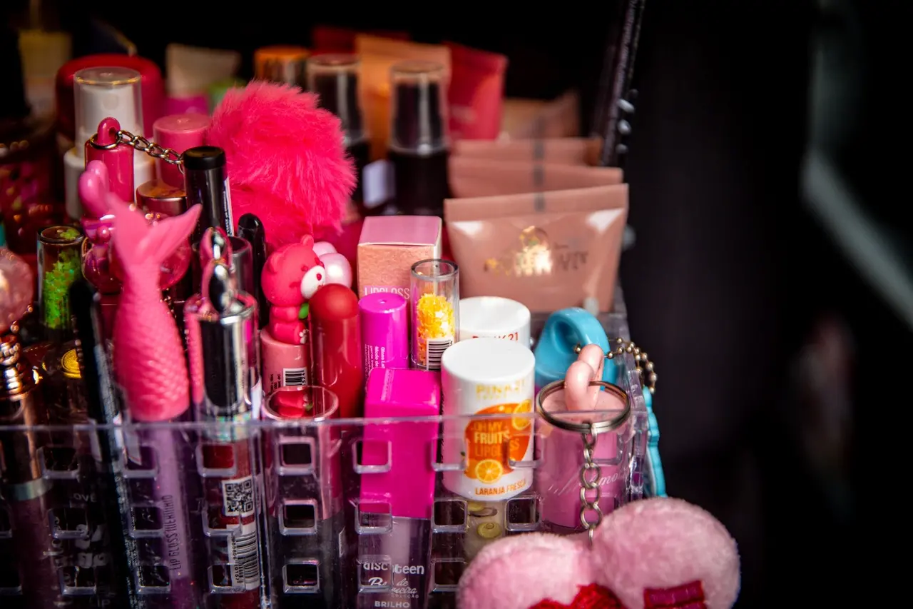 Detalhes de produtos de beleza labial, como gloss e batons.