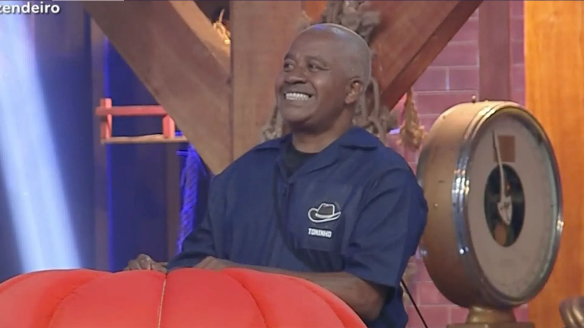 Imagem mostra Toninho Tornando sorrindo enquanto participa da Prova do Fazendeiro no reality show A Fazenda, na qual venceu a disputa pelo chapéu.