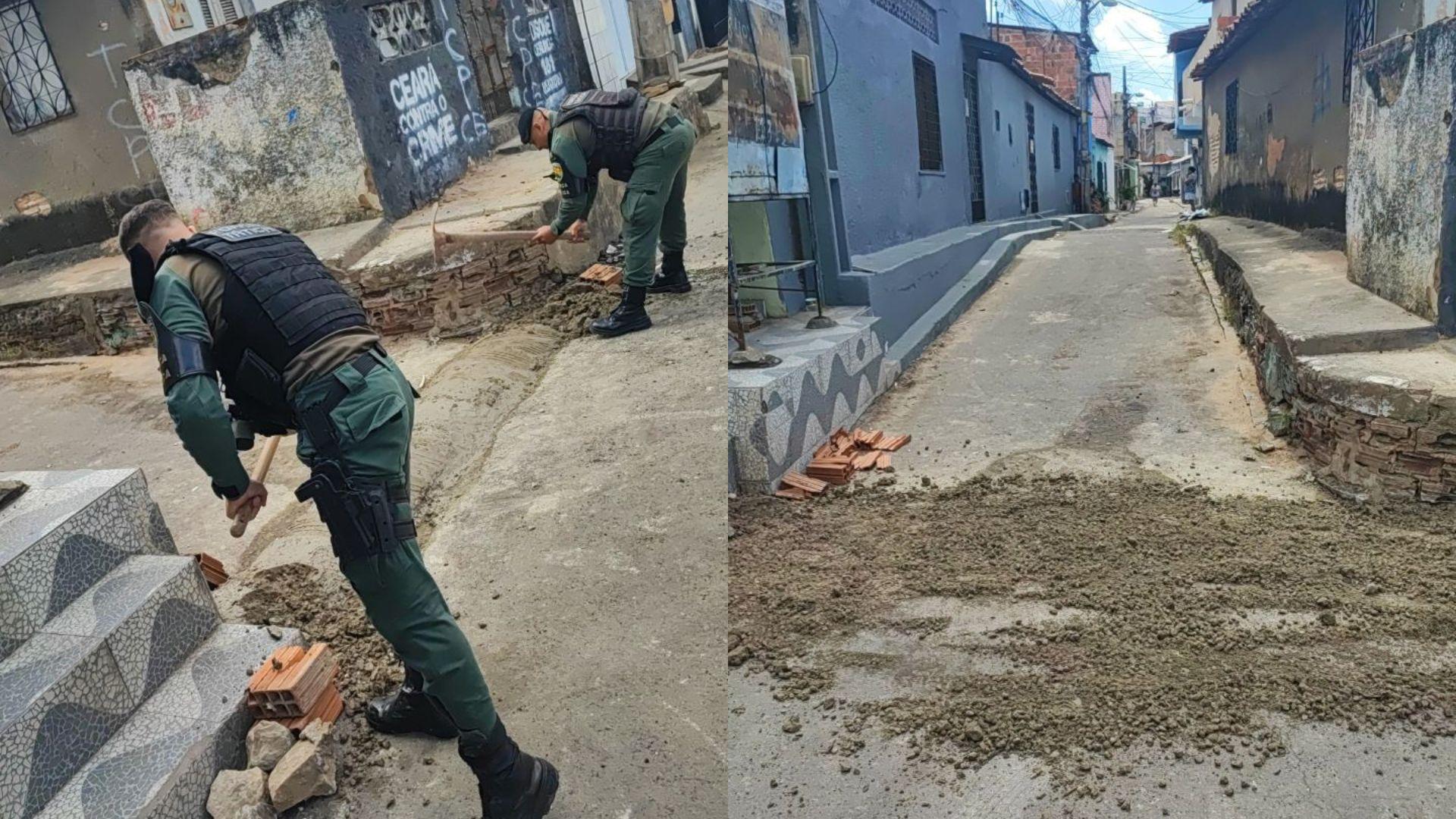 Imagem com dois policias removendo a barricada de rua na comunidade Colônia, em Fortaleza.