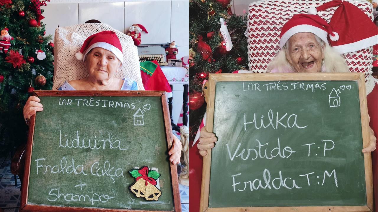 Na imagem, duas idosas segurando uma lousa com o pedido de natal, na lousa está escrito o que a idosa pediu.