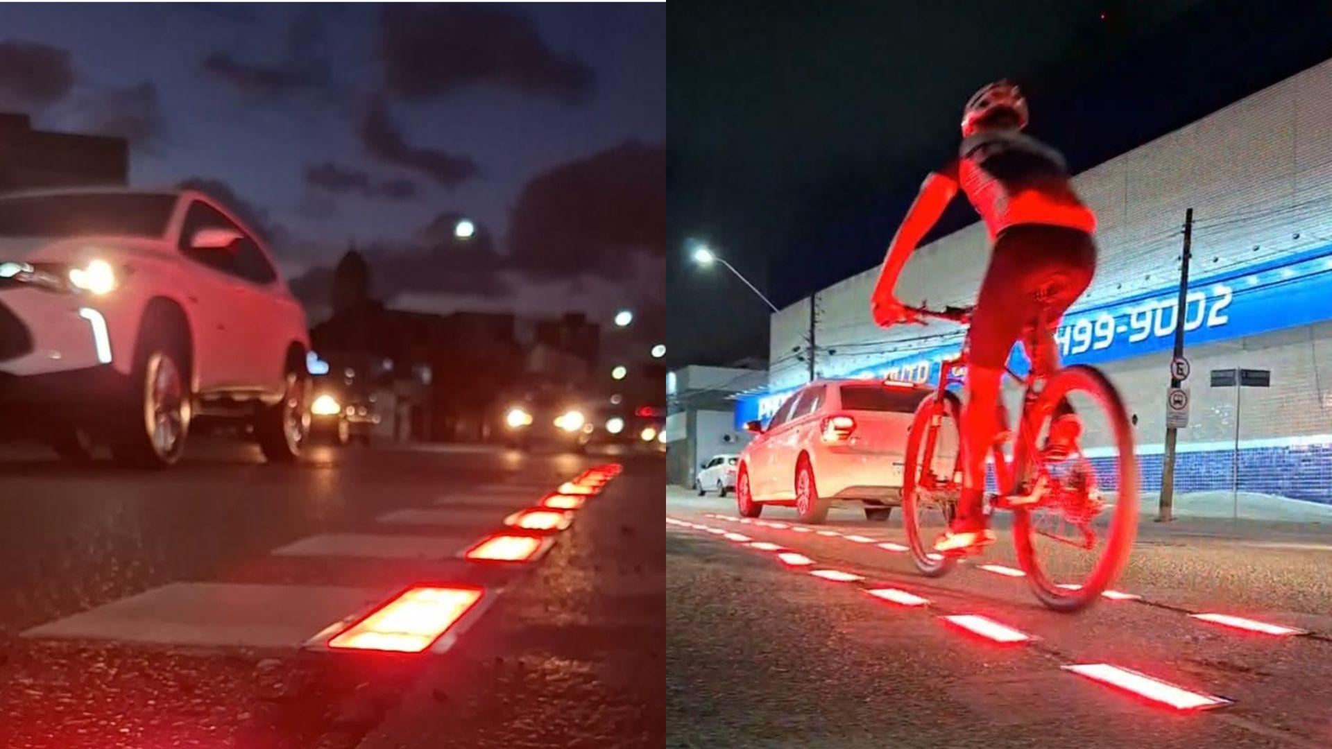 Imagem de uma rua à noite com iluminação reflexiva no chão e uma pessoa pedalando de bicicleta. Vida urbana noturna com carros e iluminação artificial.
