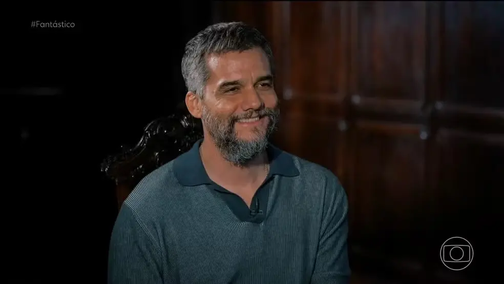 Ator sentado em entrevista para a jornalista Maju Coutinho.