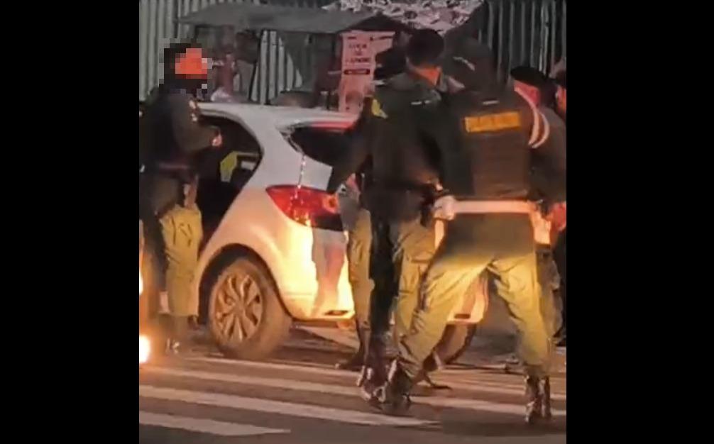 A foto mostra policiais militares, fardados, em volta de um carro branco, onde aconteceu um homicídio, em Maracanaú.