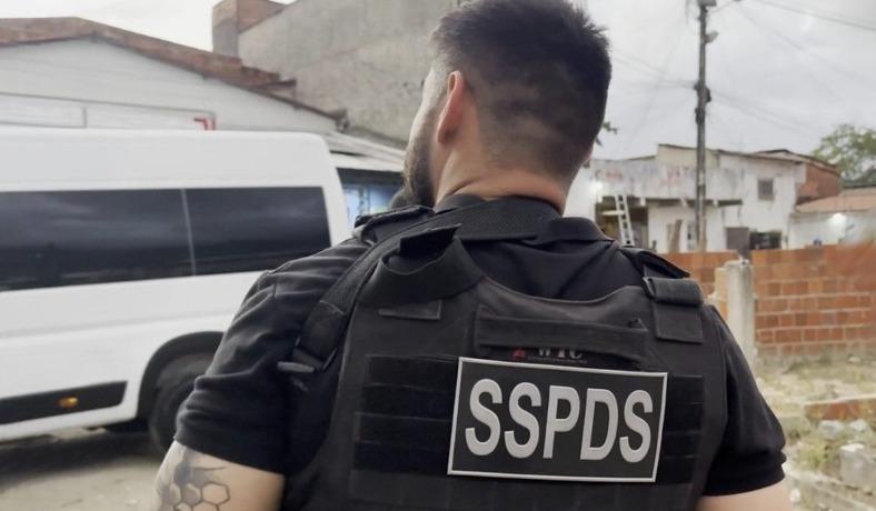 Agente de segurança de costas com colete escrito SSPDS.