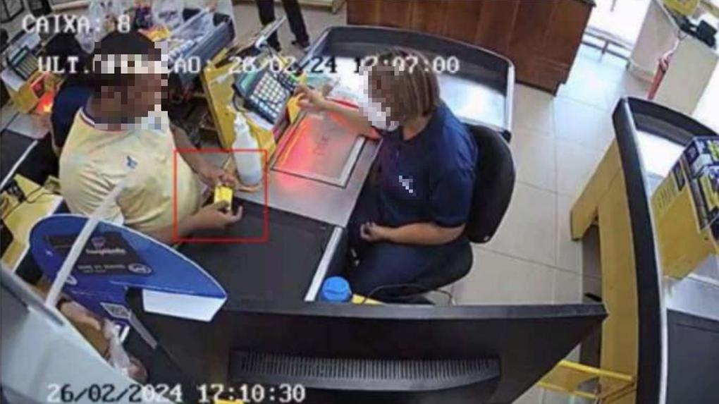 A imagem mostra um homem realizando uma compra em um caixa de um supermercado, utilizando um cartão de cor amarela, do programa social Ceará Sem Fome.