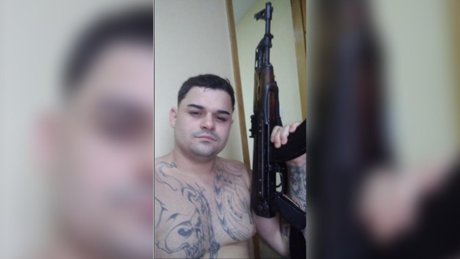 alvaro, conhecido como 2m ou paizao, segurando arma de grosso calibre.